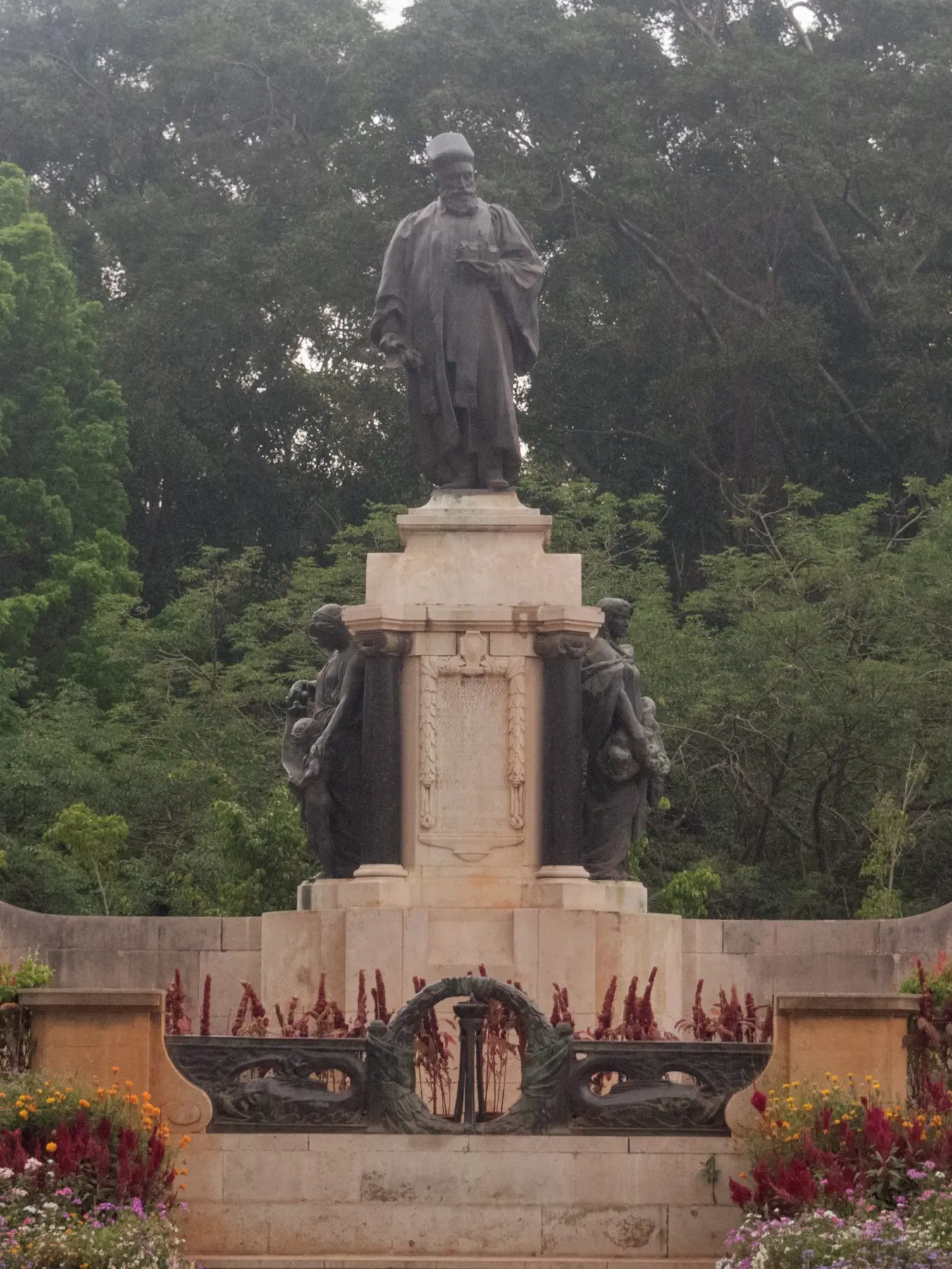Bronze statue of J N Tata holding a mini replica of the main building in his hand.