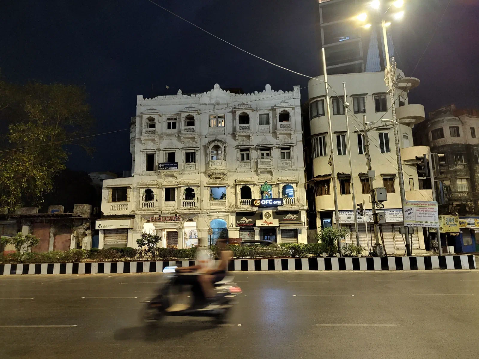 A gym with a human-sized figure of the Incredible Hulk on the signboard.
