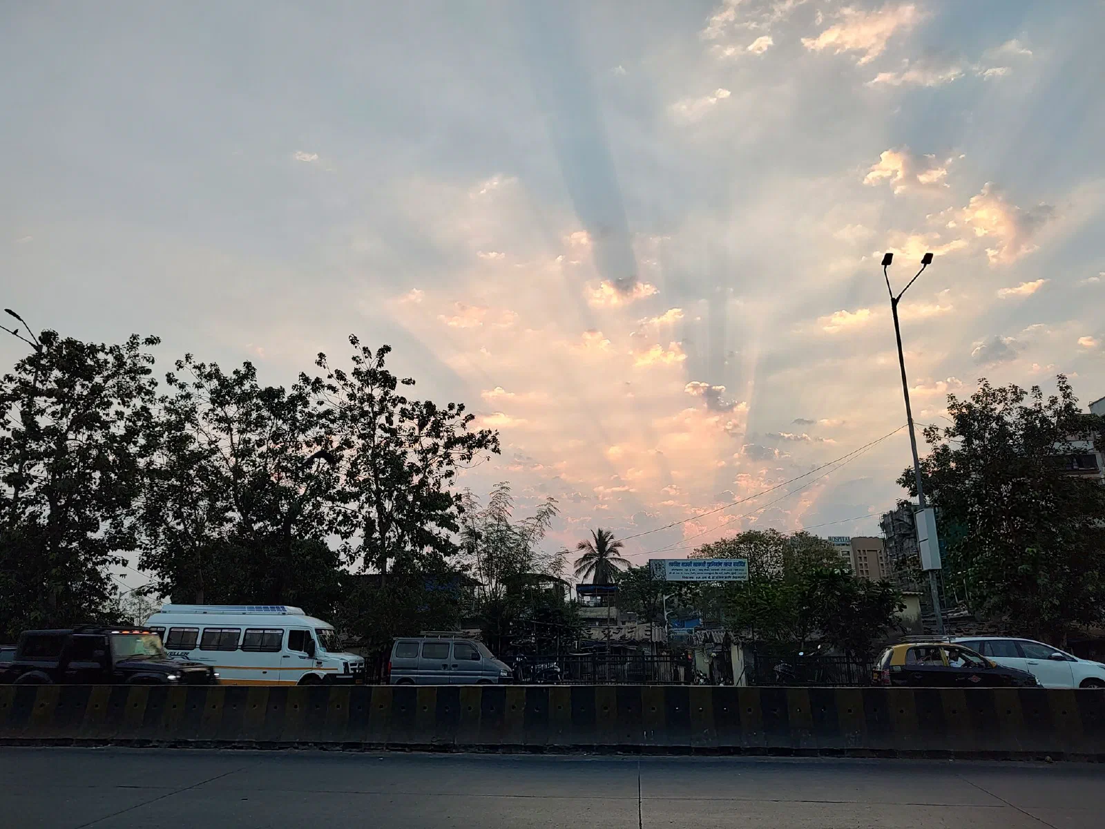 Sunrays burst through the clouds. 
