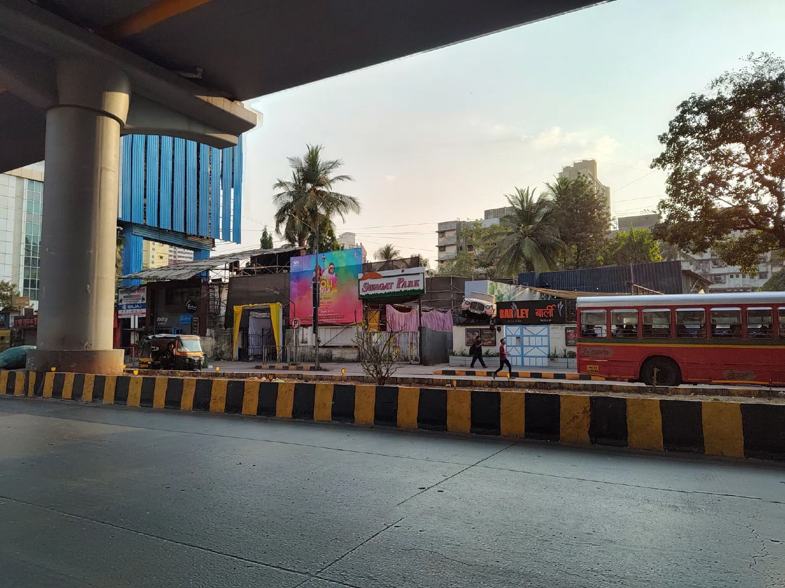A car juts out of a signboard.
