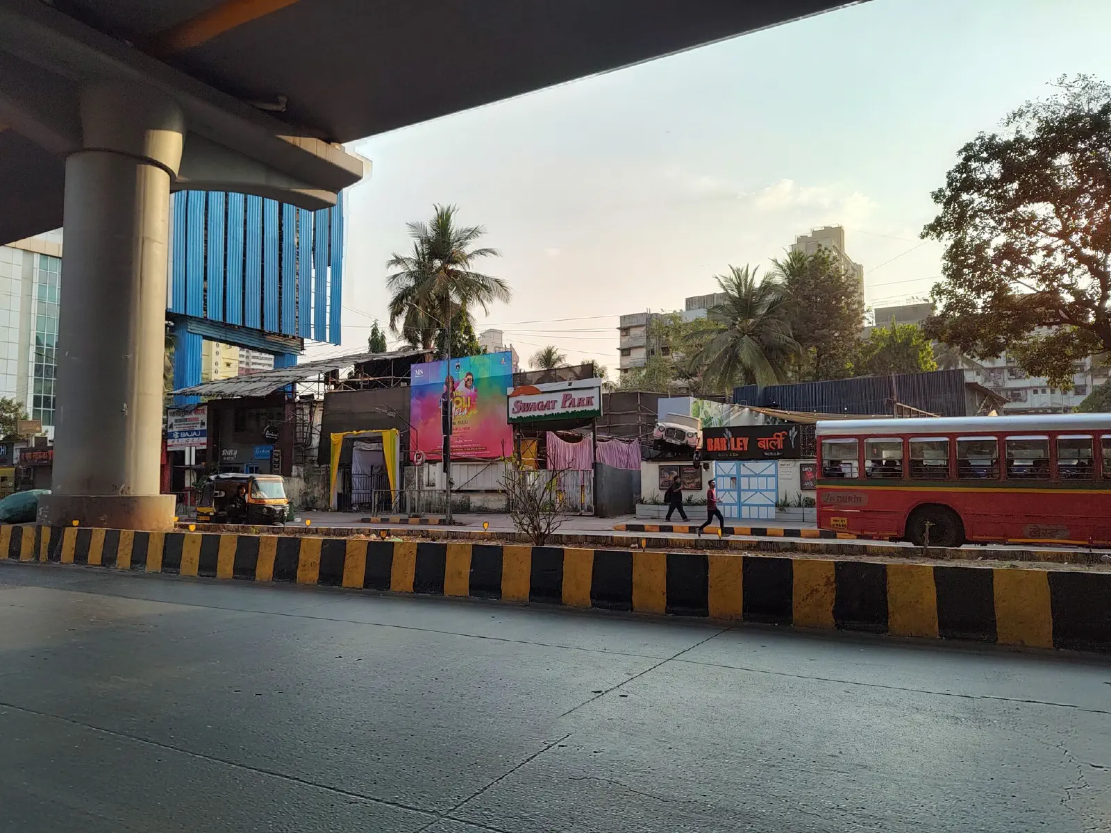 A car juts out of a signboard.
