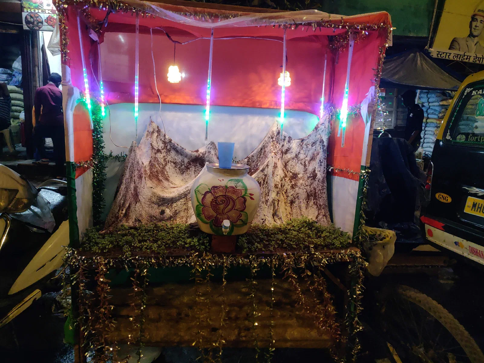 A pot of drinking water decorated with snow-capped mountains.